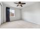 Inviting carpeted bedroom with a ceiling fan and good-sized window, creating a cozy and well-lit atmosphere at 13440 Monaco St, Thornton, CO 80602