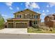 Charming two-story home with a three-car garage and a welcoming front porch at 13440 Monaco St, Thornton, CO 80602
