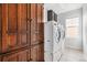 Convenient laundry area with a washer, dryer, and cabinets for easy storage at 13440 Monaco St, Thornton, CO 80602