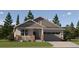 Charming single Gathering home featuring a 2-car garage, stone accents, and a well-manicured front yard at 10800 Snowdon St, Parker, CO 80134