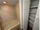 Bathroom with a combined tub and shower, plus closet with shelving at 910 S Walden St # 101, Aurora, CO 80017
