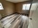 Cozy bedroom featuring modern wood-look flooring and a bright window at 910 S Walden St # 101, Aurora, CO 80017
