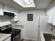 Efficient kitchen layout with white cabinets, sleek appliances, and overhead lighting at 910 S Walden St # 101, Aurora, CO 80017