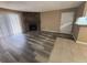 Spacious living room featuring a stone fireplace, wood flooring, and sliding door to a balcony at 910 S Walden St # 101, Aurora, CO 80017