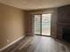 Bright living area with stone fireplace and sliding doors to a balcony with a view at 910 S Walden St # 101, Aurora, CO 80017
