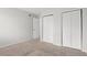 Bedroom featuring a bright window, neutral walls, double closets and neutral carpet at 1289 S Wheeling Way, Aurora, CO 80012