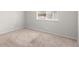 Carpeted bedroom featuring a window, neutral walls and baseboard trim at 1289 S Wheeling Way, Aurora, CO 80012