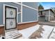 Charming blue two-story home features a secure gated entrance and brick accents at 1289 S Wheeling Way, Aurora, CO 80012