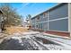 Blue home with visible house number surrounded by green space and mature trees at 1289 S Wheeling Way, Aurora, CO 80012