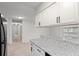 Modern kitchen area with a granite countertop bar, seamlessly connected to the living area for easy entertaining at 1289 S Wheeling Way, Aurora, CO 80012
