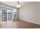 Cozy dining room illuminated by a chandelier and boasting sliding glass doors at 7353 Norfolk Pl, Castle Pines, CO 80108