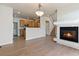 This living room features a fireplace, adjacent kitchen, and staircase at 7353 Norfolk Pl, Castle Pines, CO 80108