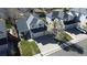 Aerial view of a two-story home with a three-car garage, a landscaped yard, and a beautiful flowering tree at 5654 S Zante Cir, Aurora, CO 80015