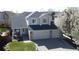 Charming two-story home featuring a covered porch, a three-car garage, and a well-manicured lawn at 5654 S Zante Cir, Aurora, CO 80015