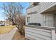 A quaint home exterior featuring gray siding, a private patio, and minimal landscaping at 17034 E Tennessee Dr # 105, Aurora, CO 80017