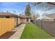 Private backyard with lush artificial grass, patio space, and modern fencing, ideal for outdoor living at 2814 N Harrison St, Denver, CO 80205