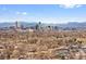 Wide aerial view of the Denver cityscape surrounded by distant mountains on a clear day at 2814 N Harrison St, Denver, CO 80205