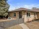 Charming single-story brick home with a well-maintained front yard and a partially fenced yard at 2814 N Harrison St, Denver, CO 80205