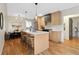 Open kitchen design with island seating, modern lighting, and adjacent dining area for seamless entertaining at 2814 N Harrison St, Denver, CO 80205