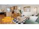 Bright living room featuring hardwood floors, modern furnishings, and an open layout connecting to the kitchen at 2814 N Harrison St, Denver, CO 80205