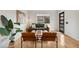 Living room featuring hardwood floors, modern furnishings, and natural light from large windows at 2814 N Harrison St, Denver, CO 80205