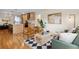 Bright living room featuring hardwood floors, modern furnishings, and an open layout connecting to the kitchen at 2814 N Harrison St, Denver, CO 80205