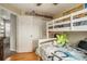 This bedroom features a bunk bed, wood flooring, and a closet at 16328 E Phillips Ln, Englewood, CO 80112