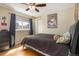 Cozy bedroom with wood floors, ceiling fan, and a comfortable bed at 16328 E Phillips Ln, Englewood, CO 80112