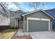 Charming two-story home with a well-maintained lawn and a two-car garage in a suburban neighborhood at 16328 E Phillips Ln, Englewood, CO 80112
