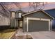 Charming home featuring a two-car garage, manicured lawn, and inviting front porch at 16328 E Phillips Ln, Englewood, CO 80112