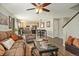 Open-concept living room and dining area with hardwood floors and stylish furnishings at 16328 E Phillips Ln, Englewood, CO 80112