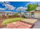 Private backyard featuring a patio, lawn, and wooden fence bordering neighboring homes at 4302 Nepal St, Denver, CO 80249
