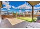 Private backyard with concrete patio, grassy lawn, and wooden fence; ideal for outdoor enjoyment at 4302 Nepal St, Denver, CO 80249