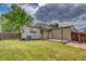 Spacious backyard featuring a well-maintained lawn and a charming patio area perfect for outdoor enjoyment at 4302 Nepal St, Denver, CO 80249