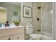Updated bathroom featuring a modern vanity, stylish fixtures, and a shower with marble-like tiling, exuding elegance at 4302 Nepal St, Denver, CO 80249