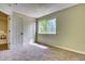 Cozy bedroom features soft carpeting, a window with natural light, and two closets providing plenty of storage at 4302 Nepal St, Denver, CO 80249
