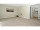 Cozy bedroom offering neutral carpeting, a charming accent table, and convenient access to the bathroom at 4302 Nepal St, Denver, CO 80249