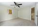 Comfortable bedroom with ceiling fan, closet space, and neutral carpet, a versatile and cozy retreat at 4302 Nepal St, Denver, CO 80249