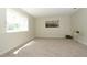 Bright bedroom with large window, neutral carpeting, and elegant artwork; perfect for relaxation at 4302 Nepal St, Denver, CO 80249