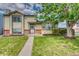 Charming home features a well-manicured lawn and lovely landscaping at 4302 Nepal St, Denver, CO 80249