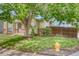 A lush green lawn and mature trees accent the home's exterior at 4302 Nepal St, Denver, CO 80249