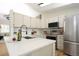 Open kitchen features stone countertops and stainless steel appliances at 4302 Nepal St, Denver, CO 80249