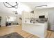 Open concept living and kitchen area boasts new hardwood flooring and fresh paint at 4302 Nepal St, Denver, CO 80249