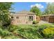Backyard showcasing a pergola covered patio for outdoor living overlooking lush greenery and a stream at 4425 Irving St, Denver, CO 80211