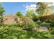 Beautiful backyard featuring a patio and lush landscaping, all set against the backdrop of mature trees at 4425 Irving St, Denver, CO 80211