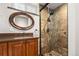 Nicely remodeled bathroom featuring a modern sink, decorative mirror, and walk-in shower with elegant tile work at 4425 Irving St, Denver, CO 80211