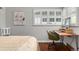 Bright bedroom featuring a wooden desk and chair set near a window with white shutters at 4425 Irving St, Denver, CO 80211