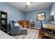 Light filled bedroom features hardwood floors, a crib, a glider and a work space at 4425 Irving St, Denver, CO 80211