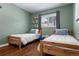 Bright bedroom featuring hardwood floors, a window with blinds, and two twin beds with bedding at 4425 Irving St, Denver, CO 80211