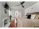 Serene bedroom featuring a fireplace, hardwood floors, and neutral décor at 4425 Irving St, Denver, CO 80211